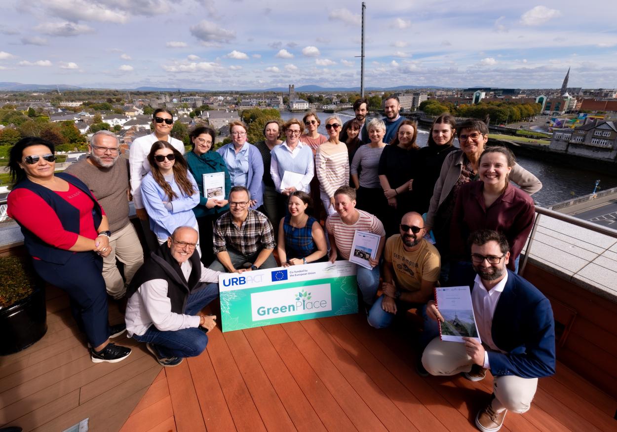 GreenPlace partners posing for a photo on the rooftop balcony.