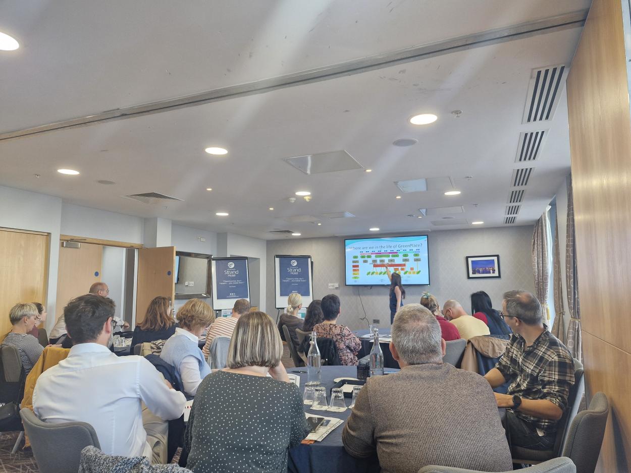 People in a conference room watching a presentation.