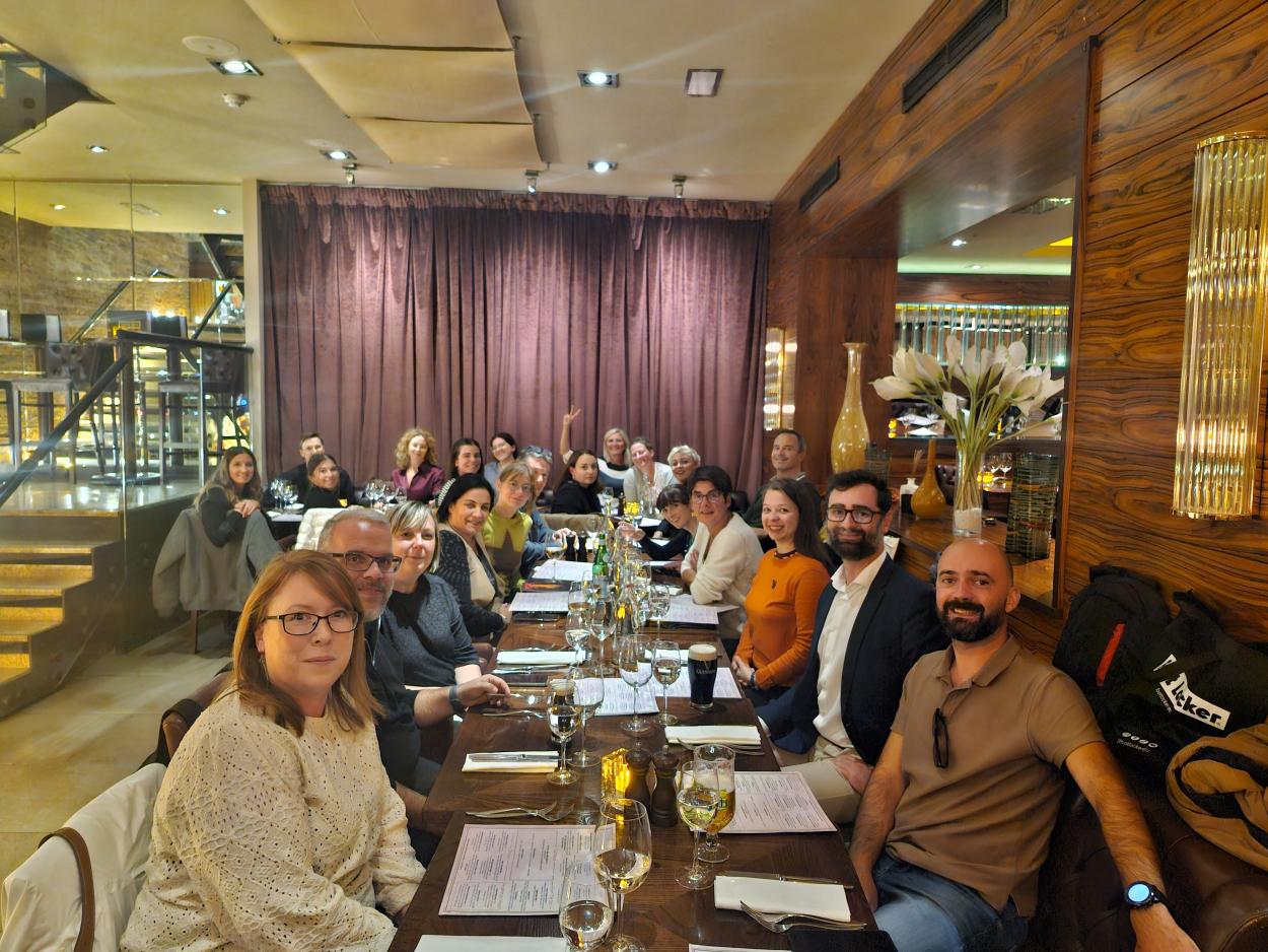 People posing for a photo at the dinner table.