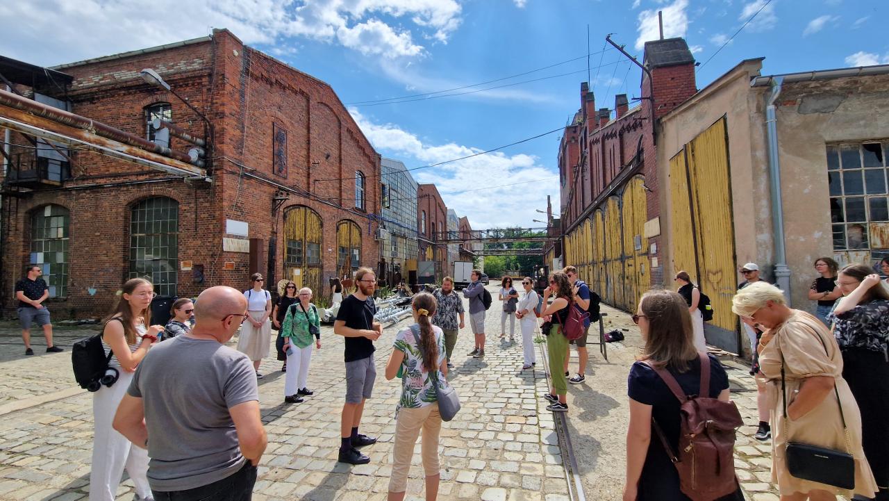 A goup of people walking around the old depot area