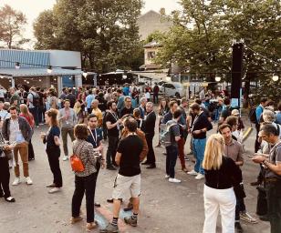 This image depicts a lively outdoor gathering or event, possibly a festival, fair, or market. 