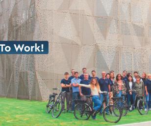 The people in the image are posing with bicycles, suggesting the theme of biking to work. 