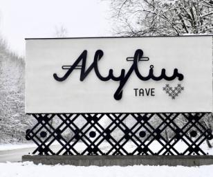 A winter scene featuring a large sign