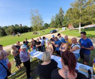 A group of people gathered outdoors in a park.