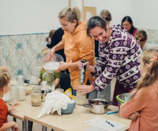 Adults and children cooking together