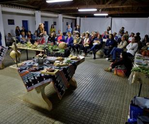 This image depicts an indoor gathering or event, possibly a cultural or community meeting.