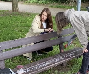 Girls painting a bench