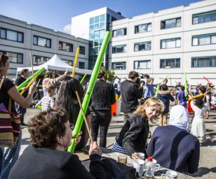 Group of people in festive outdoor setting. Catching Cultures open day. Photo by Bas van Setten for DUIC