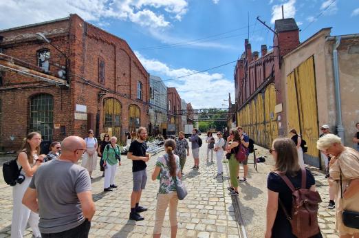 A goup of people walking around the old depot area