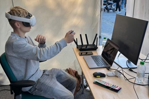 Young person using VR headset with controllers during the Metacity project’s Culture Night activity