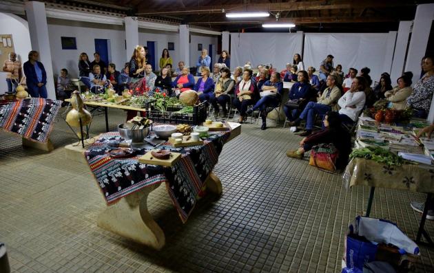 This image depicts an indoor gathering or event, possibly a cultural or community meeting.