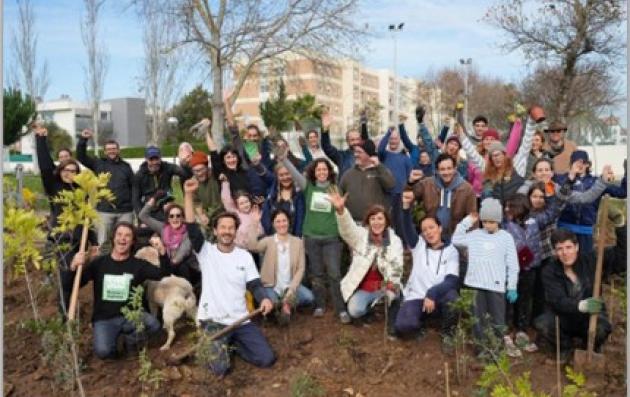 A group of people coming together to plant trees and improve their local green space.