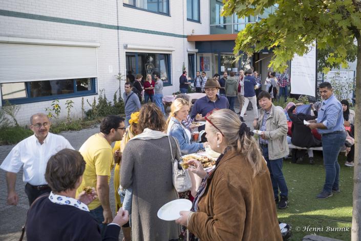 Group of people eating and talking outside