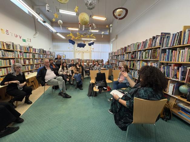 Group of people sitting in a library and talking