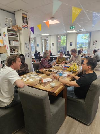 People sitting and talking at a table in a communal space