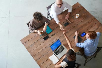 People taking agreements around a table