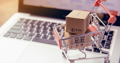 A shopping trolley on a computer keyboard. Credits: Canva.