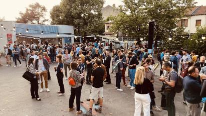 This image depicts a lively outdoor gathering or event, possibly a festival, fair, or market. 