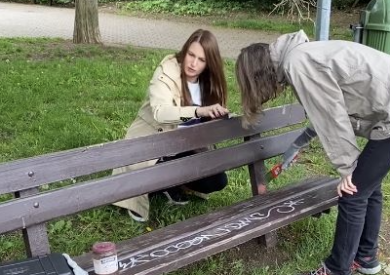 Girls painting a bench