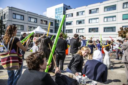 Group of people in festive outdoor setting. Catching Cultures open day. Photo by Bas van Setten for DUIC